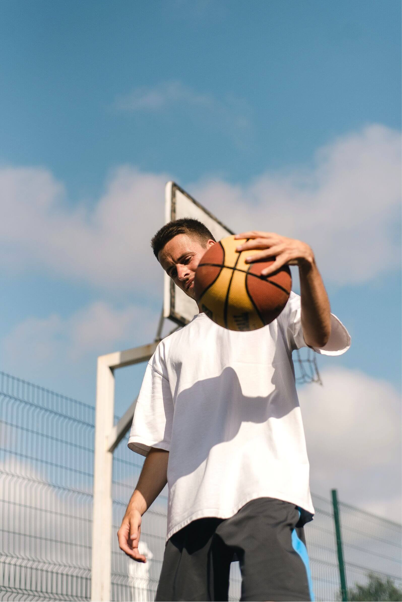 Teenage playing basketball